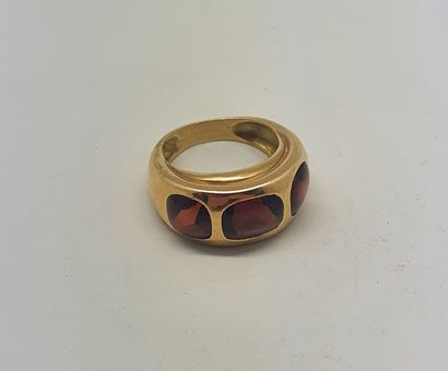 null Yellow gold ring in the shape of a large rush adorned with three red cabochon...