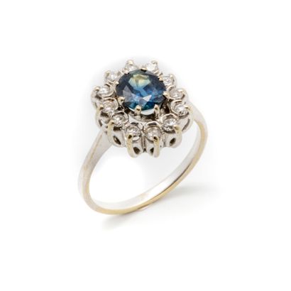 null Daisy ring in white gold with a fine blue synthetic chrysoberyl stone surrounded...