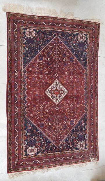 null Large woollen rug with central medallion on red background 

251 x 160 cm