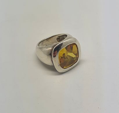null Silver ring with a yellow stone set in a closed setting