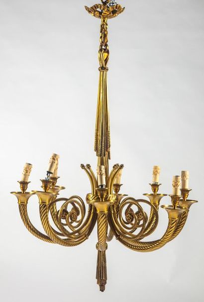 null Chandelier in gilt bronze. The central shaft in the form of a drapery holds...