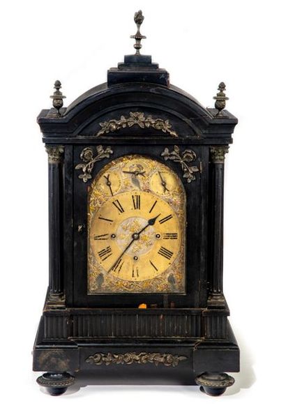 null Table clock in blackened wood. The upper part in bell decorated with three turned...