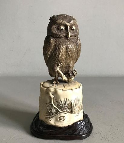 null CHINA
Statuette in bone with a patina representing an owl on a rock 
holding...