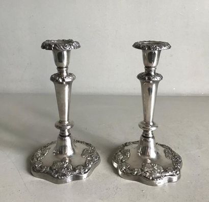 null Pair of small silver plated metal candleholders with baluster shaft. The animated...