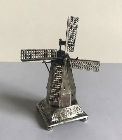 null Small silver trinket in the shape of a windmill.
Holland circa 1925 punch with...