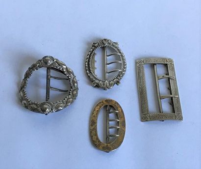 null Set consisting of four silver belt buckles (French and English) with moulded...