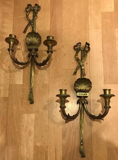 null Pair of gilt bronze sconces with two light arms chiselled with leaves and shells....