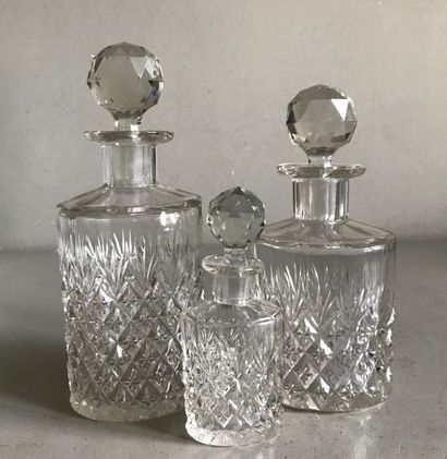 null BACCARAT attrived at 
Three faceted crystal toilet bottles with faceted caps....