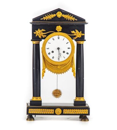 null Portico clock in black marble and ormolu ornamentation. The dial suspended between...
