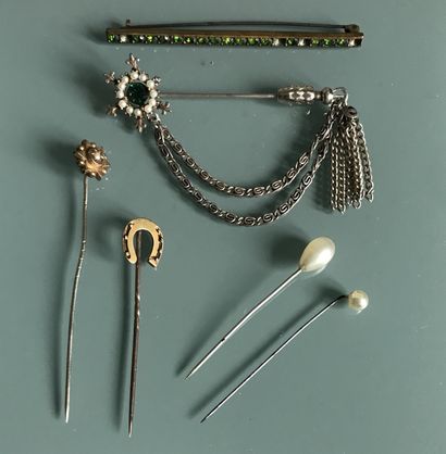 null Set of tie pins and fancy brooches.
