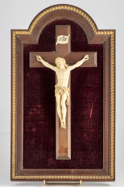null Christ in ivory (?) on a wooden cross

Wooden frame upholstered with red velvet....