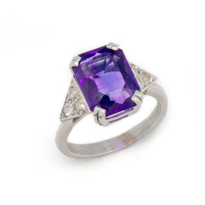 A white gold ring set with an amethyst and...