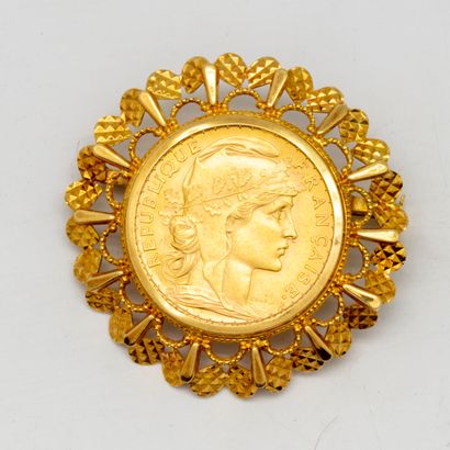 Yellow gold brooch with a 20 francs gold...