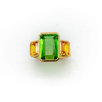 An 18k yellow gold ring set with a green...