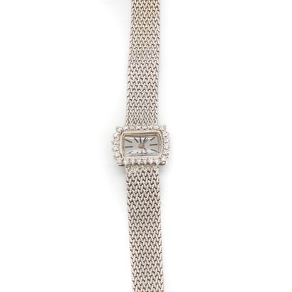 null Lady's watch in white gold, the braided bracelet, decorated with a rectangular...