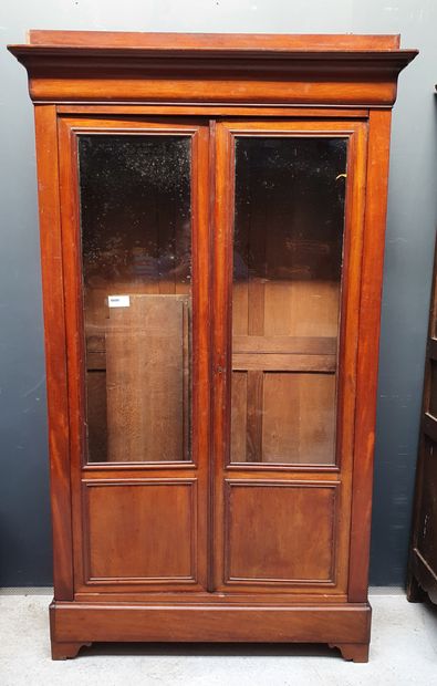 null Large mahogany veneered bookcase opening with two 3/4 glass doors. 

Middle...