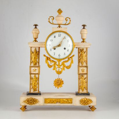 null White marble column clock with bronze appliques decorated with trophies

19th...