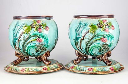 null A pair of barbotine planters with polychrome thistle decoration resting on a...