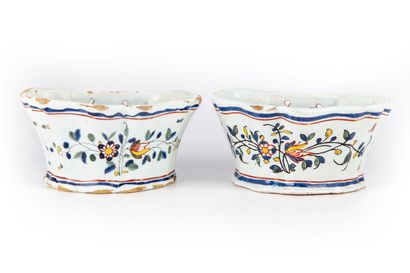 ROUEN ROUEN

A pair of glazed earthenware flowerpots decorated with foliage and flowers...