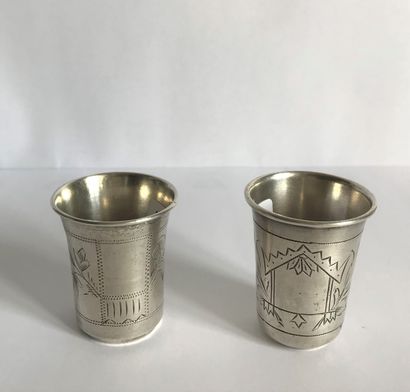 ARISTARKHOV Two silver liquor cups (not matching) engraved with a leafy cartouche.

M.O....