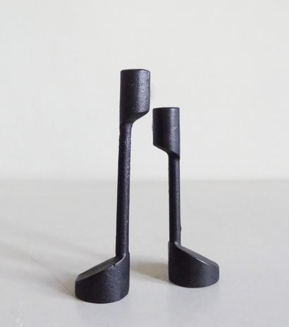 null Pair of small candlesticks of two sizes in cast iron with cylindrical base Label...