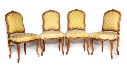 null Suite of four beech and walnut chairs with flat rounded backs, decorated with...