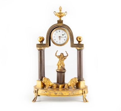 null Small bronze clock with two patinas in the form of a portico with four columns...