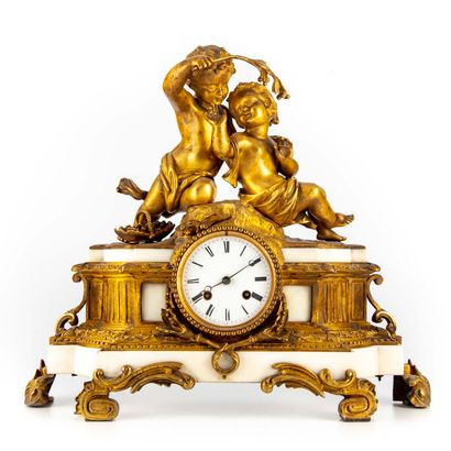 null White marble clock with rich ormolu ornamentation, surmounted by a group representing...