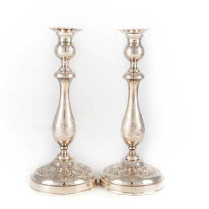 null Pair of silver plated candlesticks with turned baluster shaft finely engraved...