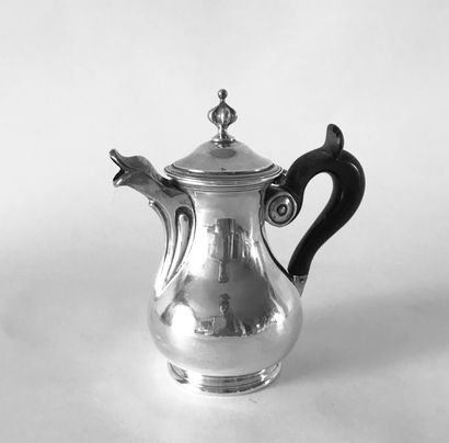 null Small selfish silver jug with a wooden handle. The spout reminds a duck's head....
