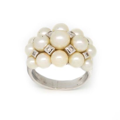 null White gold ring set with three rows of cultured pearls alternated with small...