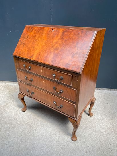 null A scribal chest of drawers in veneer opening on the top part by a flap revealing...