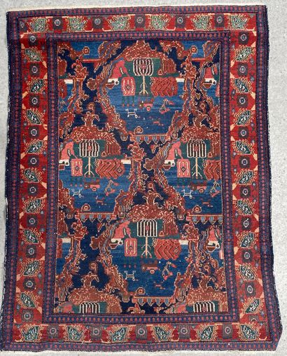 null Wool carpet with medallions forming crescents on a blue field. Large floral...