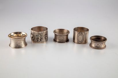 null Set of four silver napkin rings. One silver napkin ring chased with an indian...