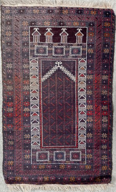 null Woolen prayer rug with geometric patterns on a grey-green field framed by four...