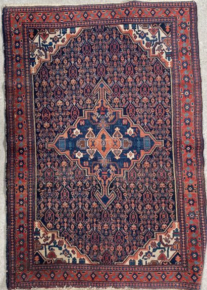 null Woolen carpet with a central medallion motif on a dark field decorated with...