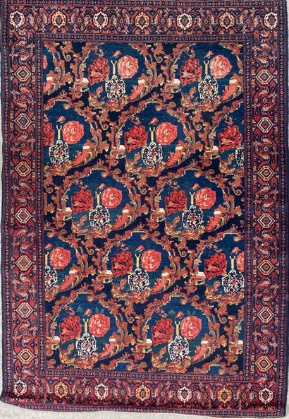 null Woolen carpet with a pattern of medallions forming crescents on a blue field....