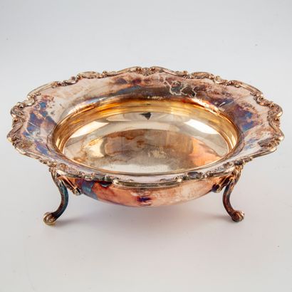 null A round silver cup with a chiselled edge, resting on three curved feet.

English...