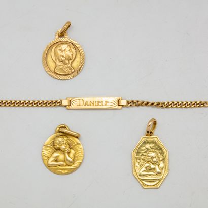 null Lot including a small engraved gold bracelet and three small religious medals...