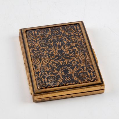 null Fifth Avenue

A gilt metal make-up case with engraved decoration on a black...