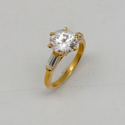 Yellow gold ring set with a synthetic diamond...