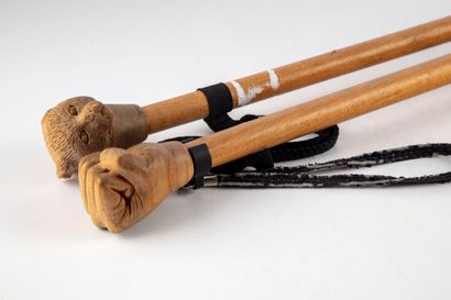 null Set of two wooden canes, one with a hand and the other with a weasel head

H.:...