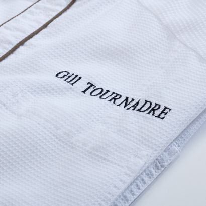 null Chef Gilles Tournadre's kitchen jacket, embroidered with his name, awarded two...