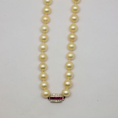 null River pearl necklace with a white gold clasp set with calibrated red stones...
