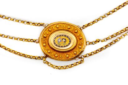  Yellow gold drapery necklace with an oval medallion decorated with flowers and enamel...