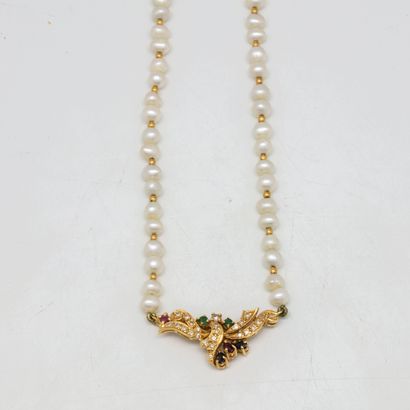 null Small cultured pearl necklace, decorated with a central gold motif punctuated...