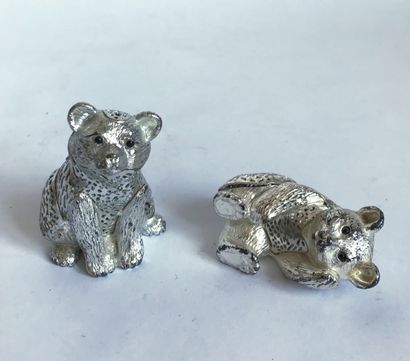 CHRISTOFLE CHRISTOFLE

Two silver-plated metal trinkets representing teddy bears,...