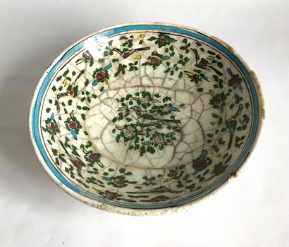 PERSE PERSE

Earthenware bowl on a small heel decorated with flowers and birds. Qadjar...