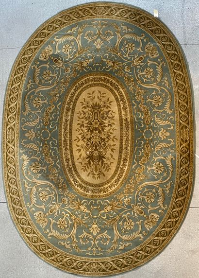 Oval carpet decorated with garlands and foliage...