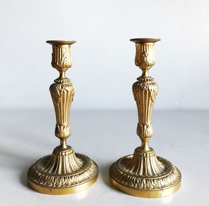 null Pair of ormolu candlesticks molded and chased with flutes, acanthus leaves,...